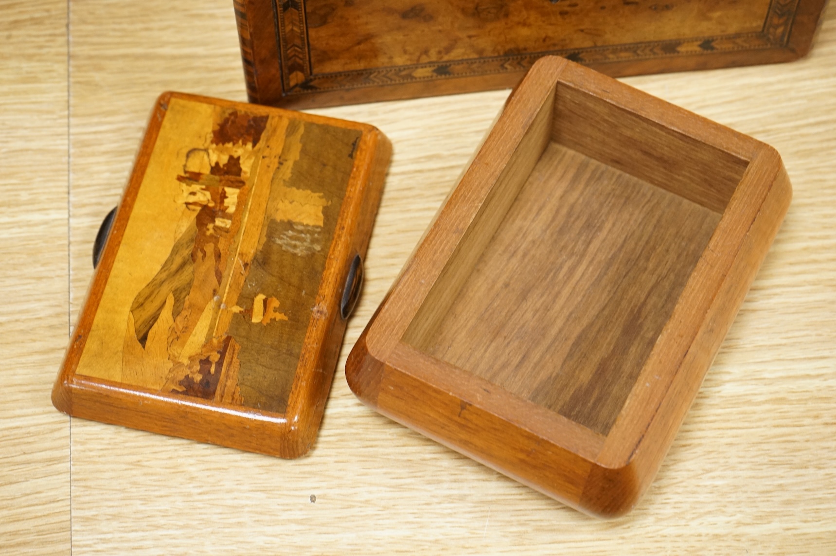 A walnut and German bandwork tea caddy, a brass bound walnut writing slope and an Art Deco Killarney inlaid trinket box, largest 15cm high, 30cm wide.